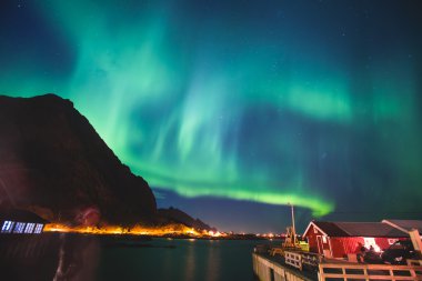 Beautiful picture of massive multicoloured vibrant Aurora Borealis, Aurora Polaris, also know as Northern Lights in the night sky over Norway, Lofoten Islands clipart