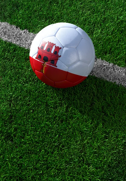 Soccer ball and national flag of Gibraltar,  green grass — Stock Photo, Image