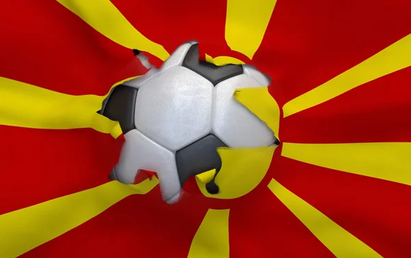 O buraco na bandeira da Macedônia e bola de futebol — Fotografia de Stock