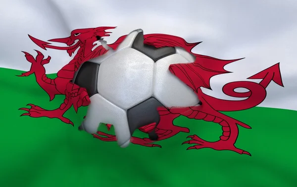 The hole in the flag of Wales and soccer ball — Stock Photo, Image