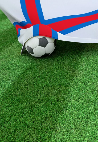 Soccer ball and national flag of Faroe Islands,  green grass — Stock Photo, Image