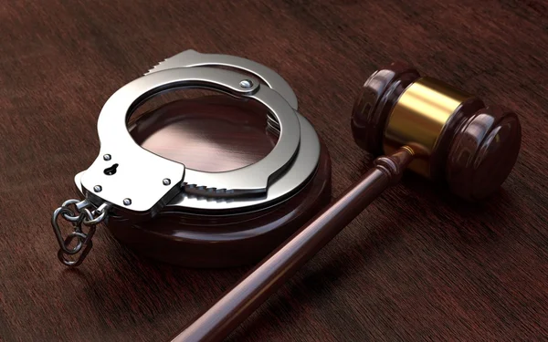 Gavel and handcuffs on wooden table background — Stock Photo, Image