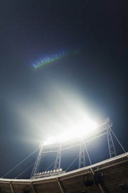 View of stadium lights at night clipart