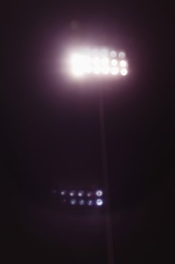View of stadium lights at night clipart
