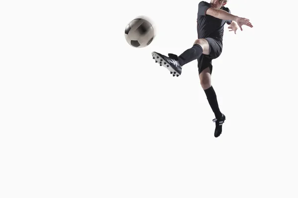 Athlete kicking soccer ball — Stock Photo, Image