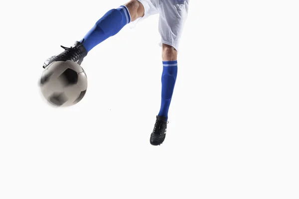 Athlete kicking soccer ball — Stock Photo, Image