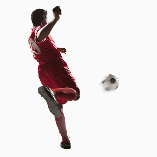 Soccer player kicking soccer ball — Stock Photo, Image