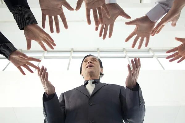 Crowd Reaching for Businessman — Stock Photo, Image