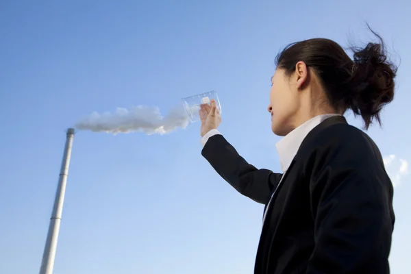 Businesswoman Collecting Smoke in Beaker — Stock Photo, Image