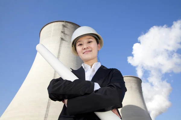 Engineer in front of cooling towers — Stock Photo, Image