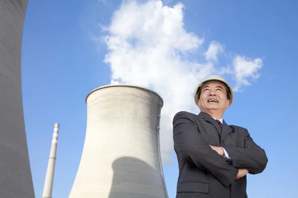 Businessman in front of cooling tower — Stock Photo, Image
