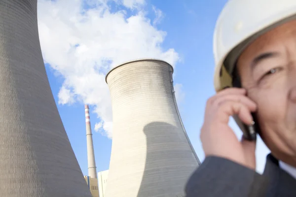 Businessman on mobile phone at power plant — Stock Photo, Image