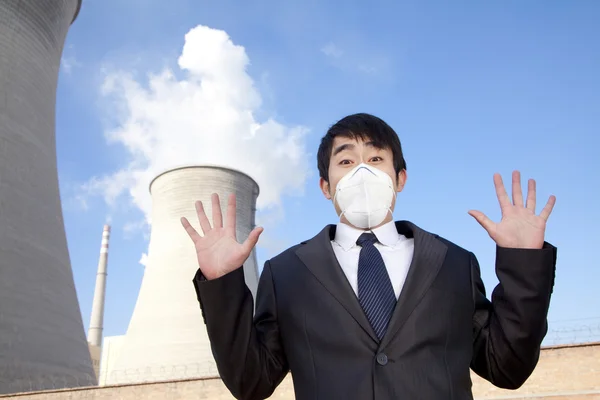 Businessman at power plant with face mask — Stock Photo, Image