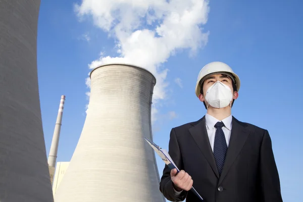 Businessman at power plant with face mask — Stock Photo, Image