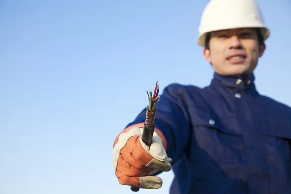 Manual worker with frayed wire — Stock Photo, Image