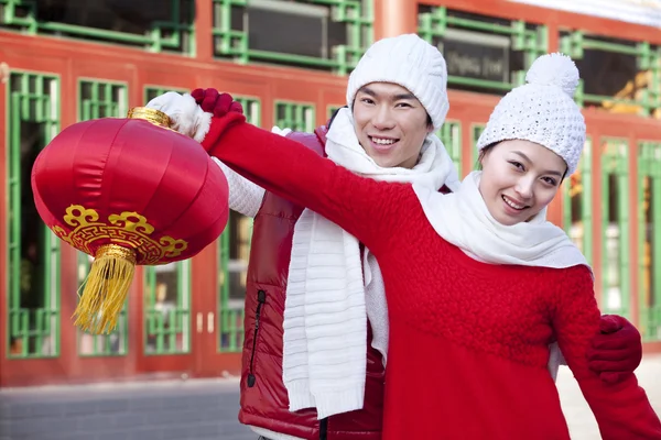 Young couple holding red lantern — Stock Photo, Image