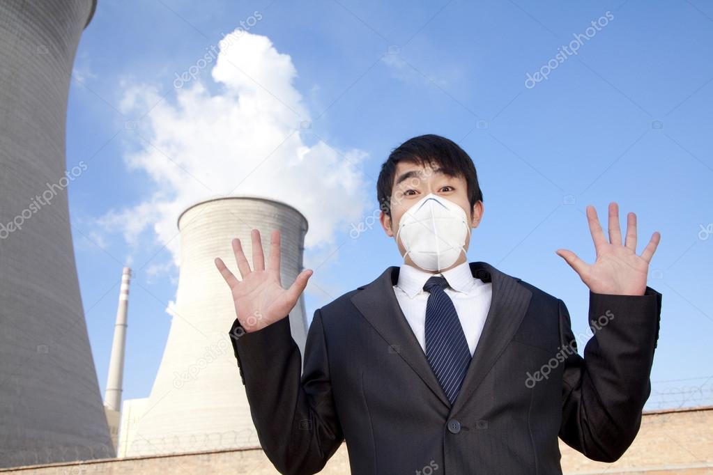 Businessman at power plant with face mask