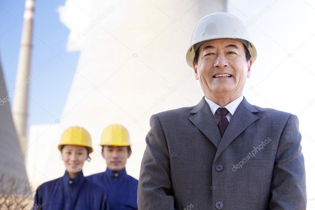 Businessman and workers in hardhats