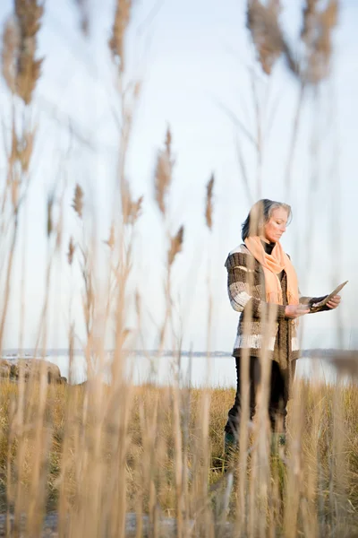 Mature woman standing on a marsh — Stock Photo, Image