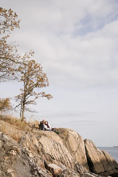 Pareja madura descansando sobre rocas — Foto de Stock