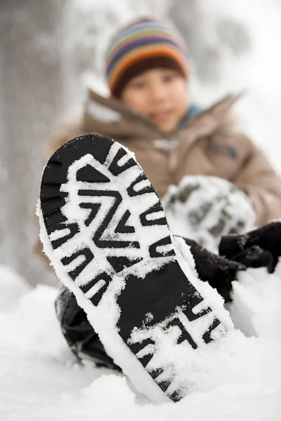 男孩与他的鞋上的雪 — 图库照片