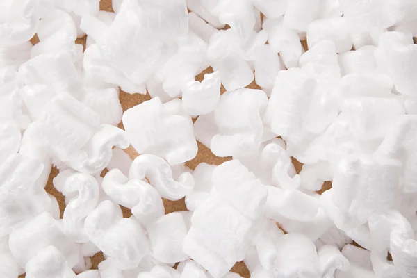 Styrofoam peanuts in shipping box — Stock Photo, Image