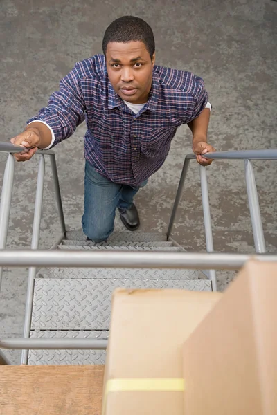 Man climbing steps — Stock Photo, Image