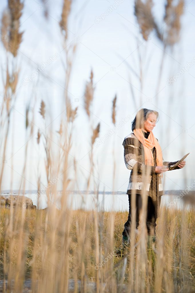Mature woman standing on a marsh