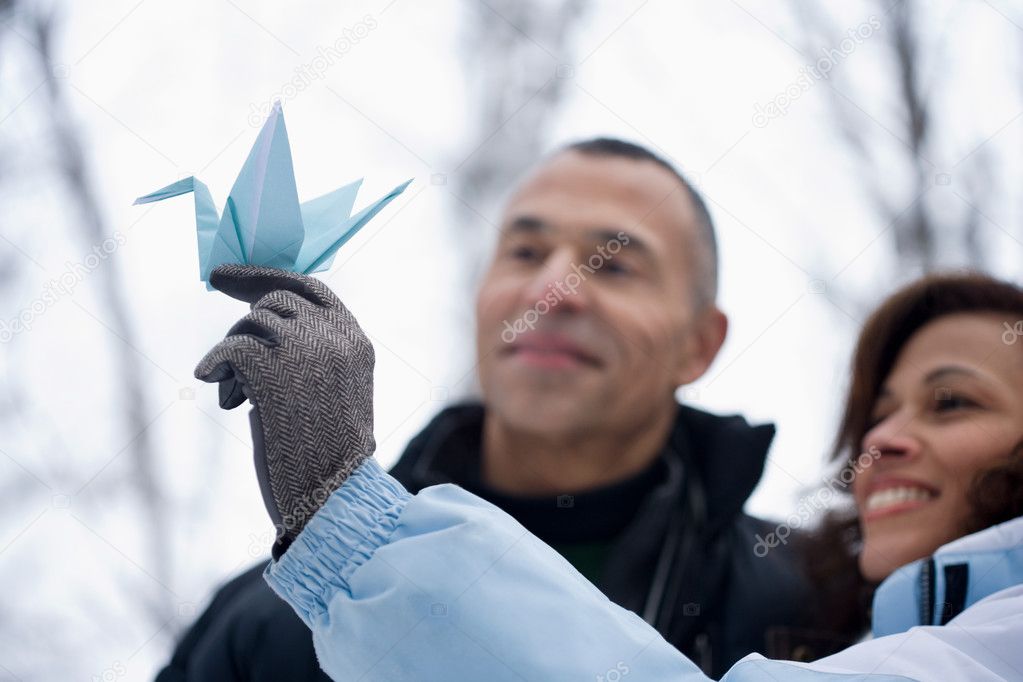 woman holding an origami