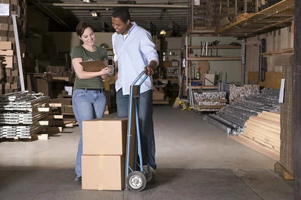 Colleagues in warehouse working — Stock Photo, Image