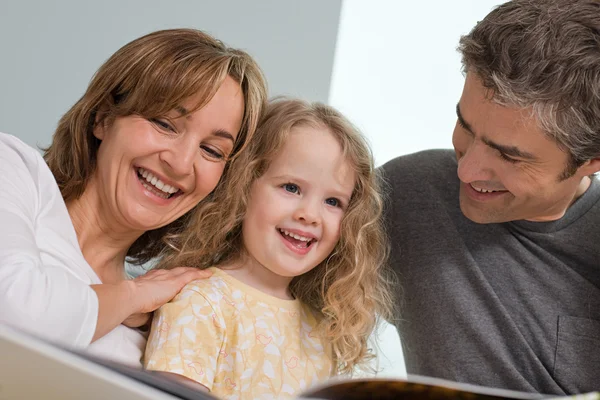 Familjen läser en bok — Stockfoto