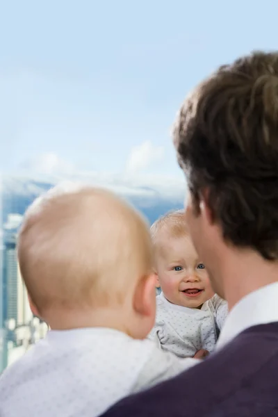 Vader en zoon op zoek in een venster — Stockfoto