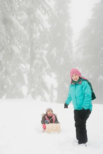 Mor och dotter med kälke — Stockfoto