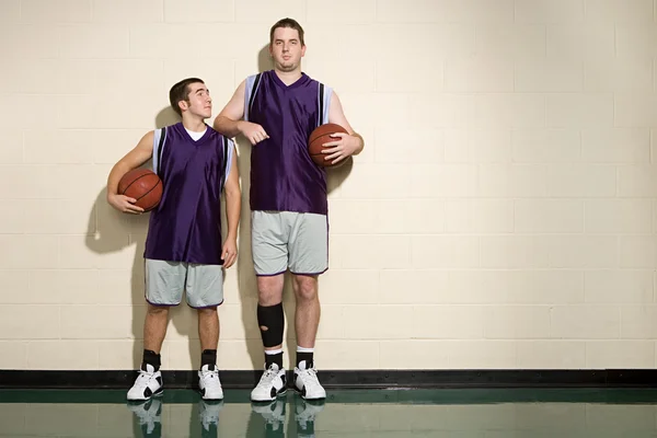 Tall and short basketball players Royalty Free Stock Photos