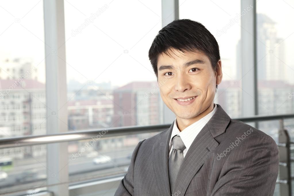 Young Businessman in front of window