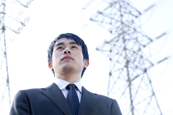 Businessman in Front of Power Lines — Stock Photo, Image