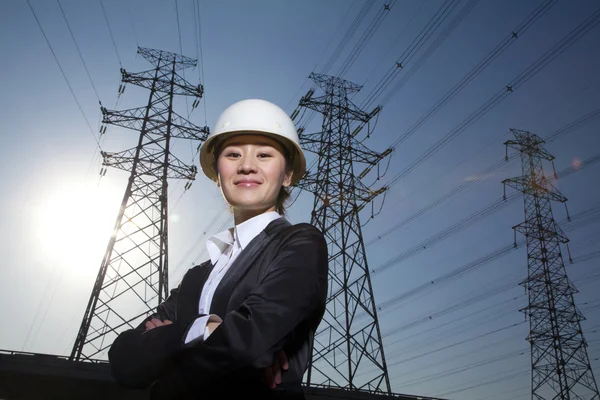 Femme d'affaires devant les lignes électriques — Photo