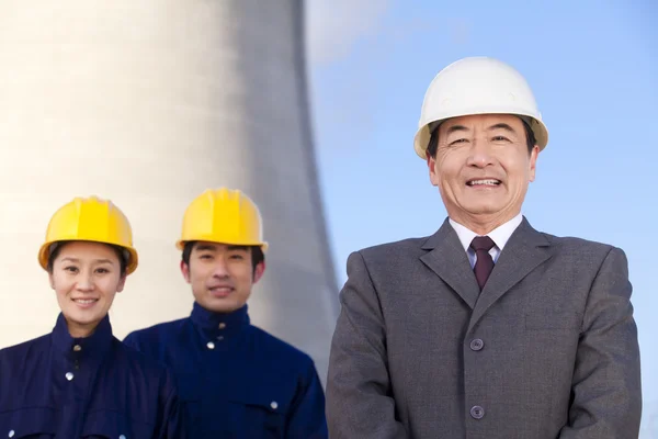 Businessman and workers in hardhats — Stock Photo, Image