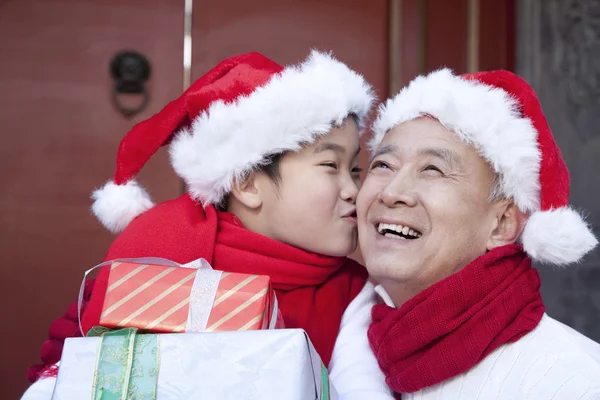 Grandpa and grandson holding Christmas Gifts — Stock Photo, Image