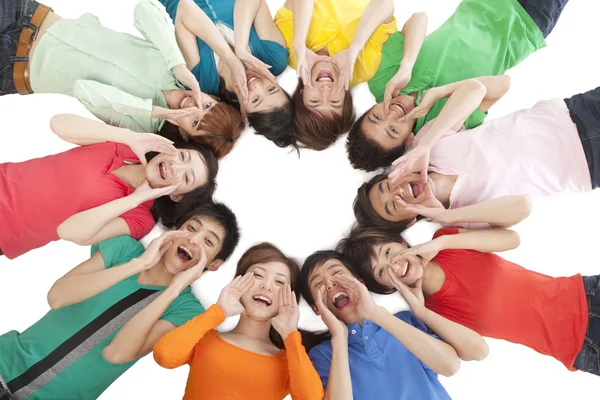 A group of young people shouting in a circle — Stock Photo, Image