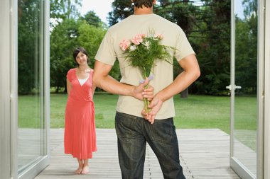 Man surprising wife with flowers clipart