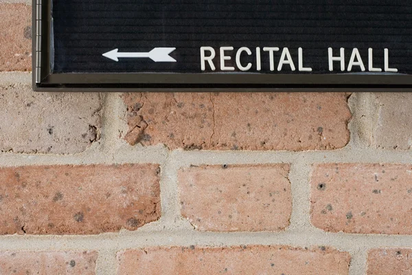 Recital hall sign on brick wall — Stock Photo, Image