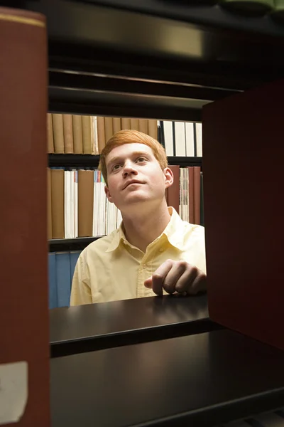 Mannelijke student studeren in de bibliotheek — Stockfoto