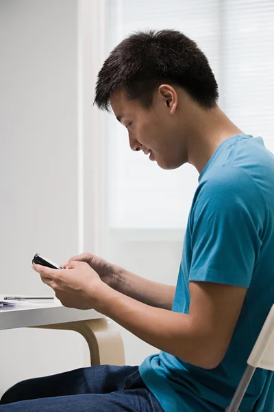 Jeune homme utilisant un téléphone portable — Photo