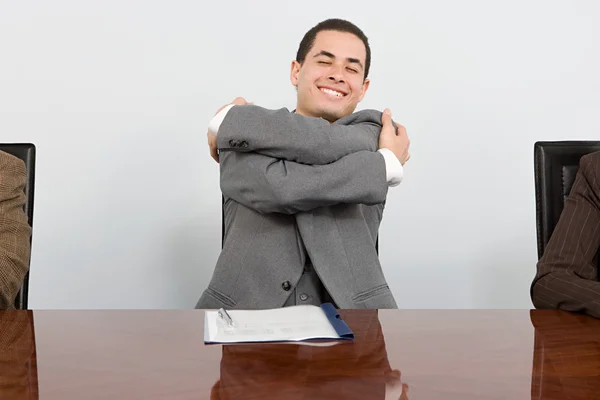 Businessman hugging himself — Stock Photo, Image