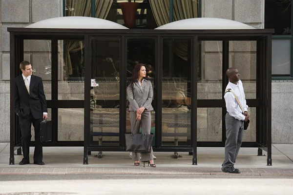 People waiting at bus stop — Stock Photo, Image