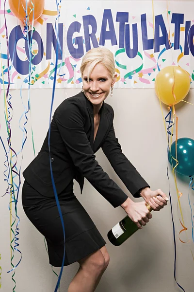 Affärskvinna öppning flaska champagne — Stockfoto