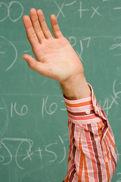 Male student with his hand raised — Stock Photo, Image