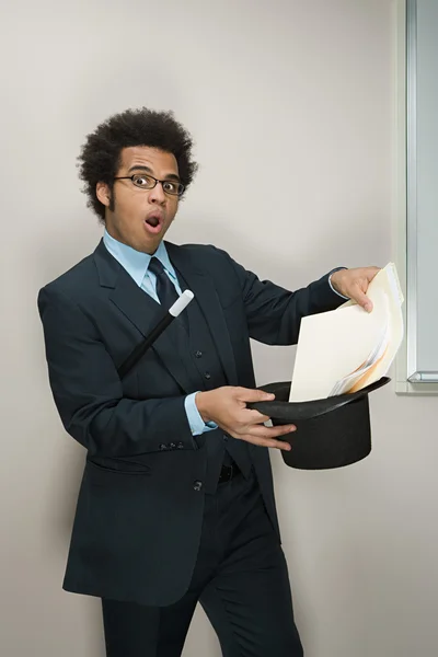 Businessman performing magic tricks — Stock Photo, Image