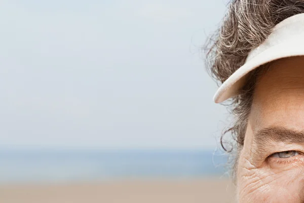 Close up of woman wearing a sun visor — Stock Photo, Image